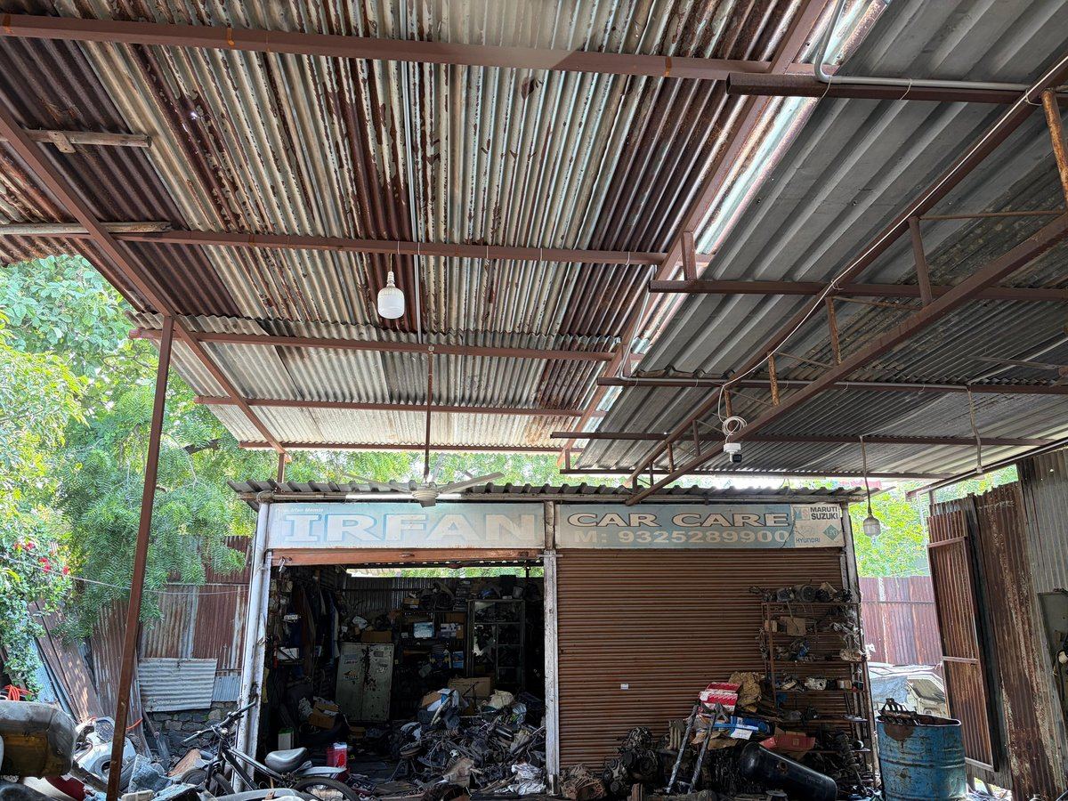 Inside Irfan Car Care workshop showing tools, parts and work bays